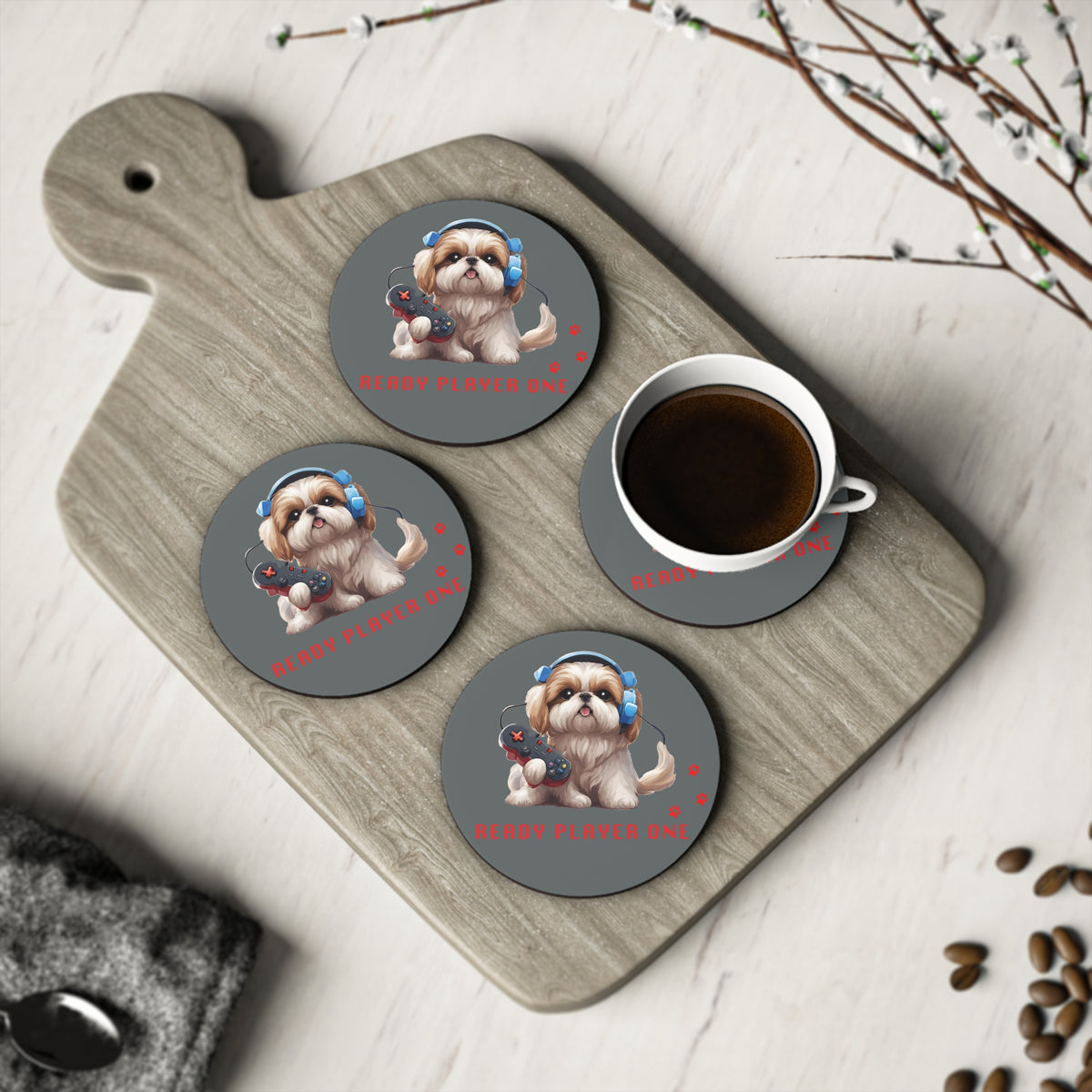 Four #18 Ready Player One round coasters on a board with a cup of coffee