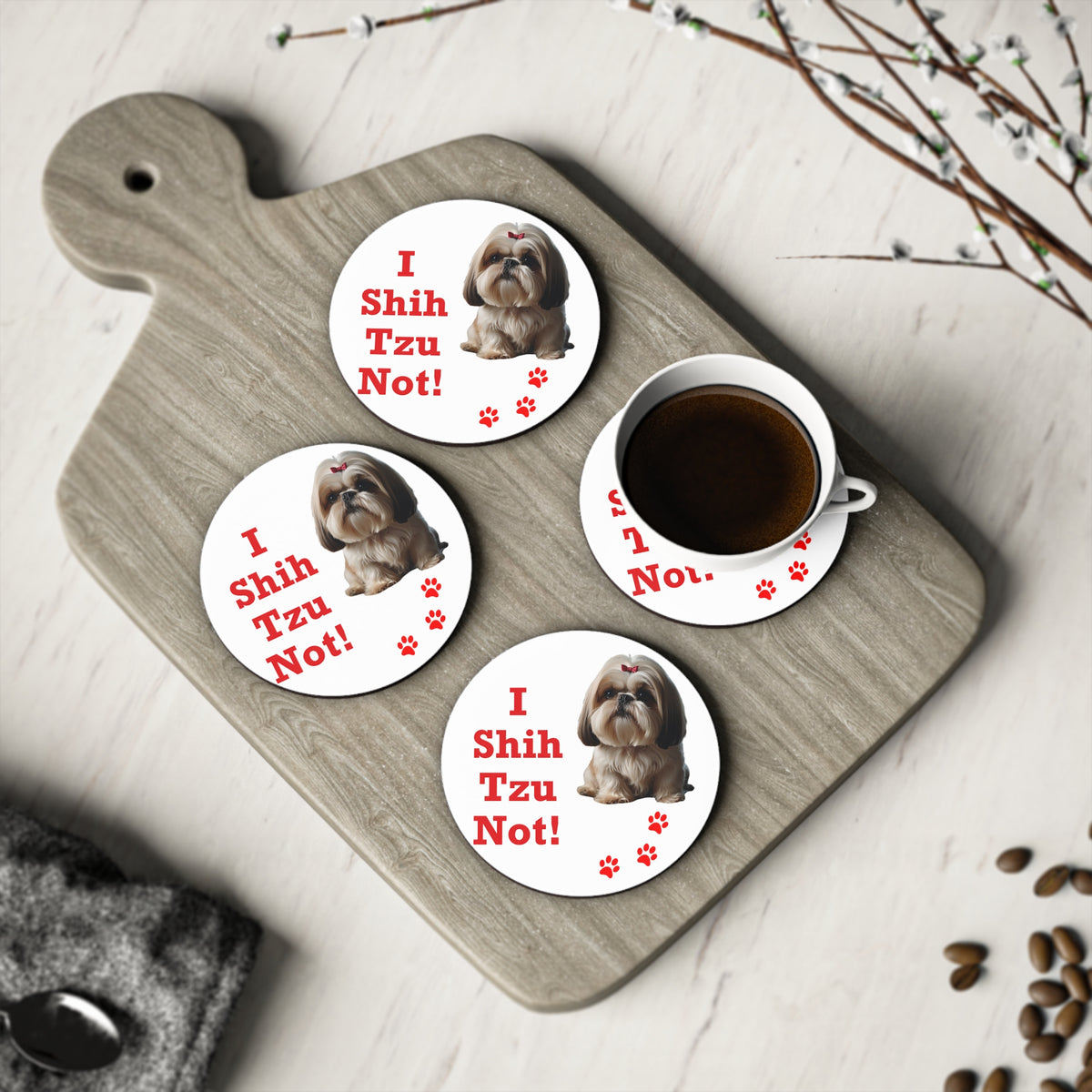 Four #19 I Shih Tzu Not round coasters on a board with a cup of coffee