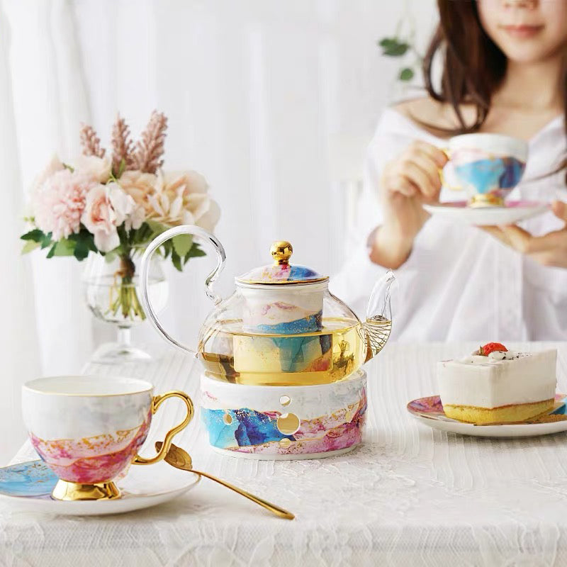 The tea service in use, a cup being lifted from its saucer