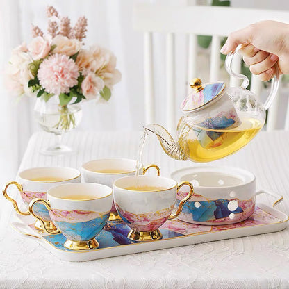English glass and bone china tea service, teapot on its warmer with four cups on the tray