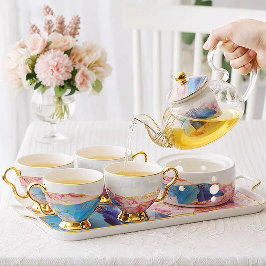 English glass and bone china tea service, teapot on its warmer with four cups on the tray