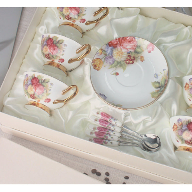 Close view of the bouquet of roses and summer flowers on the cups and saucer