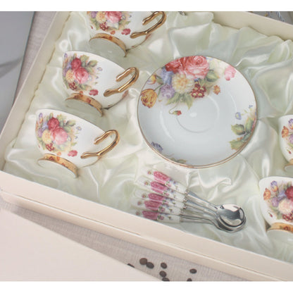 Close view of the bouquet of roses and summer flowers on the cups and saucer